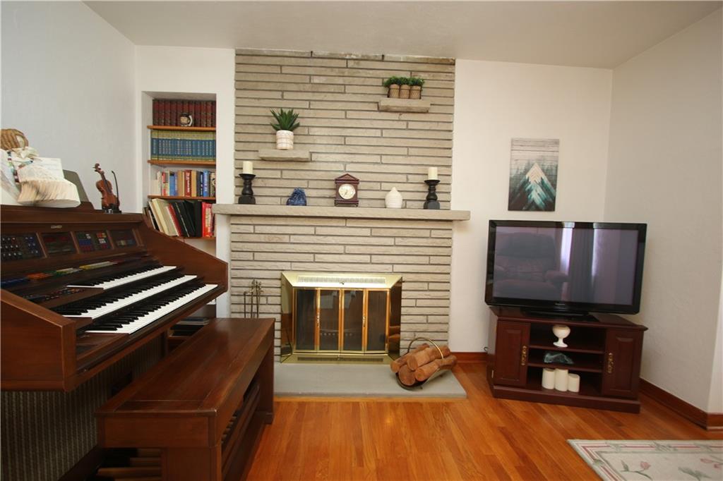 157 Taylor Run Road Monongahela, PA 15063 - Photo 3 of 42 Beautiful Stone Wood Burning Fireplace w/ Stone Mantles & Built-in Stone Shelves accented w/ Brass around Glass Doors & Stone Hearth. (Chimney Cap & Screen installed 2020 as well as both Fireplaces Cleaned)