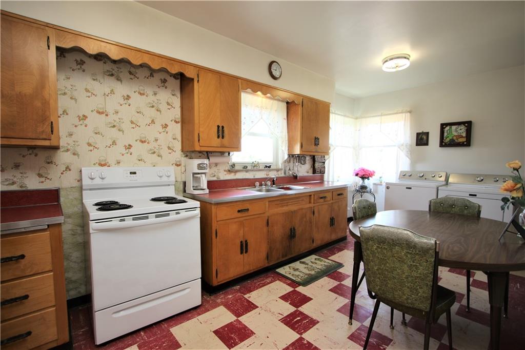 157 Taylor Run Road Monongahela, PA 15063 - Photo 7 of 42 Spacious 19x9 Eat-in Kitchen w/ Plenty of Wood Cabinets, Corner Windows allowing the Natural Light to continue to be invited inside & convenience of Washer & Dryer on 1st Floor! (hook-ups also downstairs if preferred). Also featuring a side Door to Covered Porch w/ New Aluminum Awning (7-23)