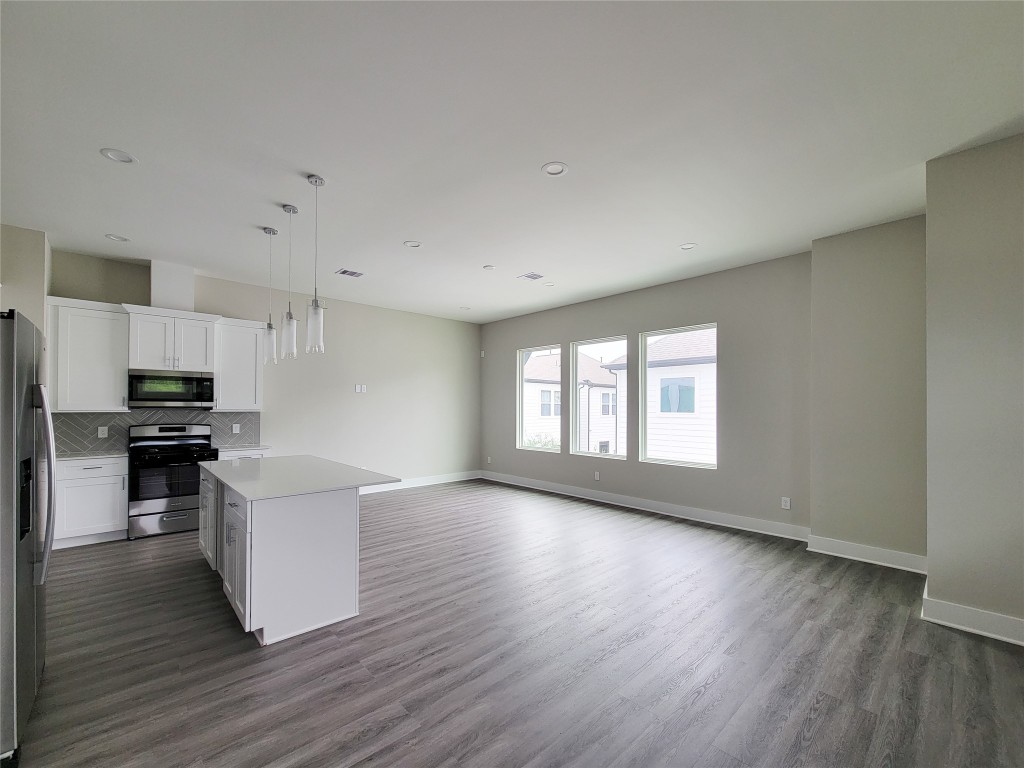 8316 Curry Road, Unit A Houston, TX 77093 - Photo 18 of 47 a view of kitchen with microwave a stove and wooden floor