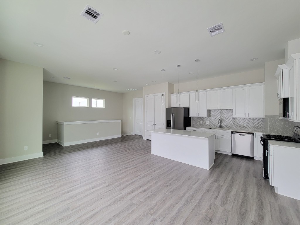 8316 Curry Road, Unit A Houston, TX 77093 - Photo 21 of 47 a view of kitchen with wooden floor and electronic appliances