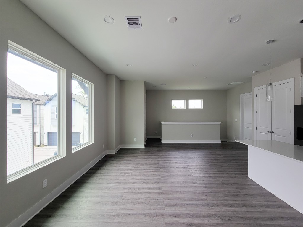 8316 Curry Road, Unit A Houston, TX 77093 - Photo 22 of 47 a view of an empty room with wooden floor and a window
