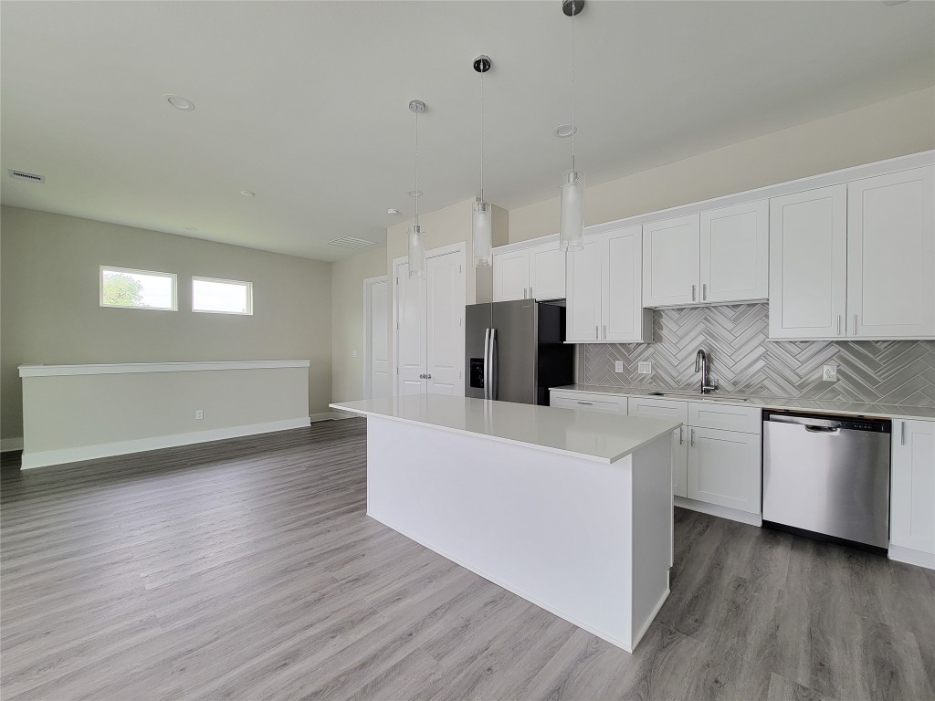 8316 Curry Road, Unit A Houston, TX 77093 - Photo 23 of 47 a kitchen with stainless steel appliances a refrigerator sink and white cabinets