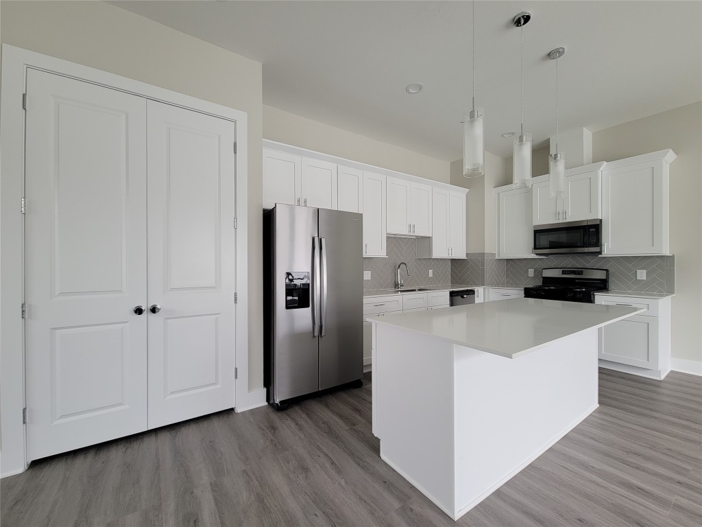 8316 Curry Road, Unit A Houston, TX 77093 - Photo 25 of 47 a kitchen with stainless steel appliances a refrigerator sink and white cabinets