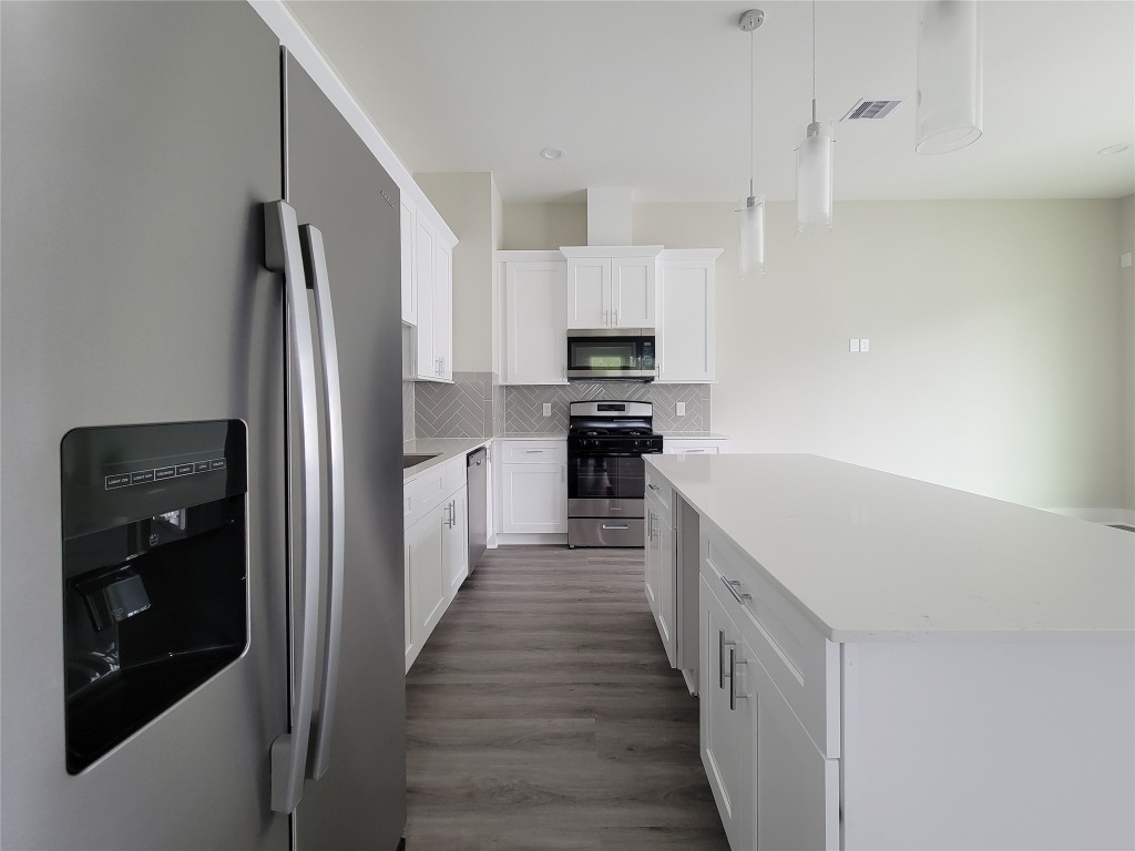 8316 Curry Road, Unit A Houston, TX 77093 - Photo 27 of 47 a kitchen with stainless steel appliances a refrigerator and a stove top oven