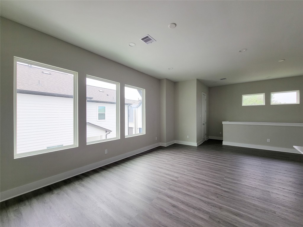 8316 Curry Road, Unit A Houston, TX 77093 - Photo 31 of 47 an empty room with wooden floor and windows