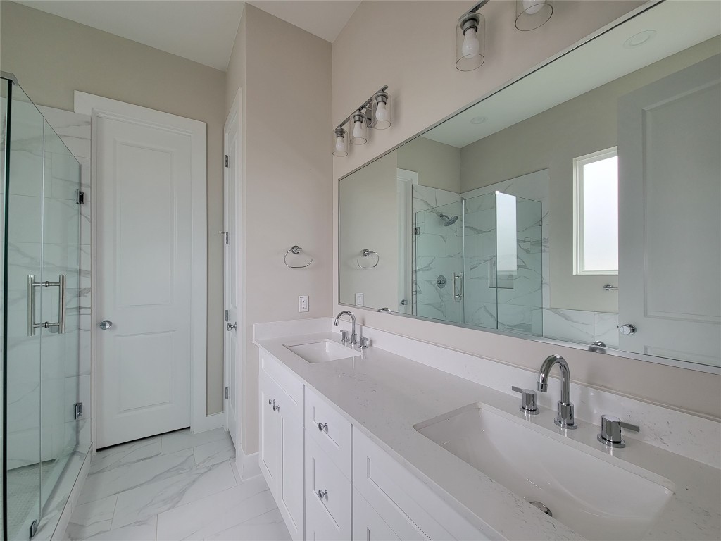 8316 Curry Road, Unit A Houston, TX 77093 - Photo 37 of 47 a bathroom with double vanity sinks and a mirror