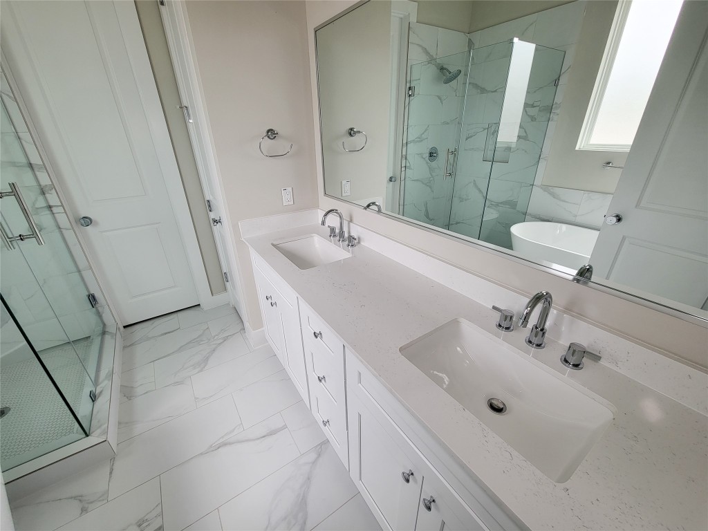 8316 Curry Road, Unit A Houston, TX 77093 - Photo 38 of 47 a bathroom with a double vanity sink and mirror