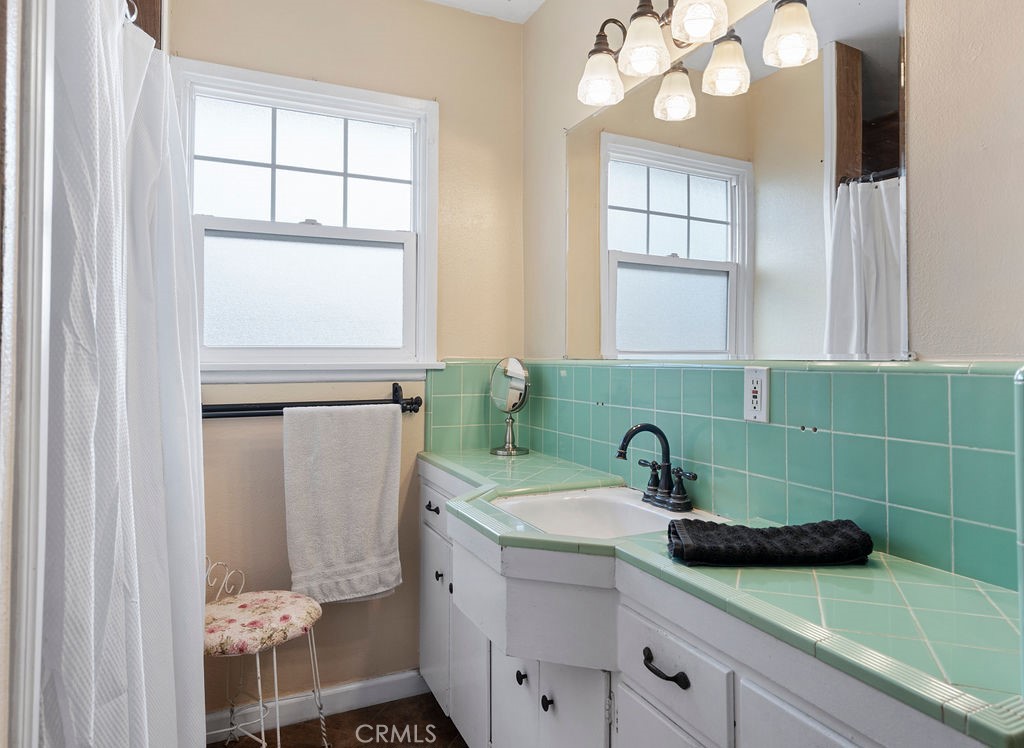 1338 Delay Avenue Glendora, CA 91740 - Photo 25 of 46 a bathroom with a sink a mirror and a window