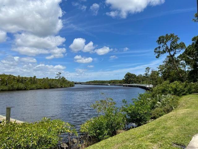 2500 Southeast Anchorage Cove, Unit D3 Port St. Lucie, FL 34952 - Photo 1 of 51 a view of a lake from a yard