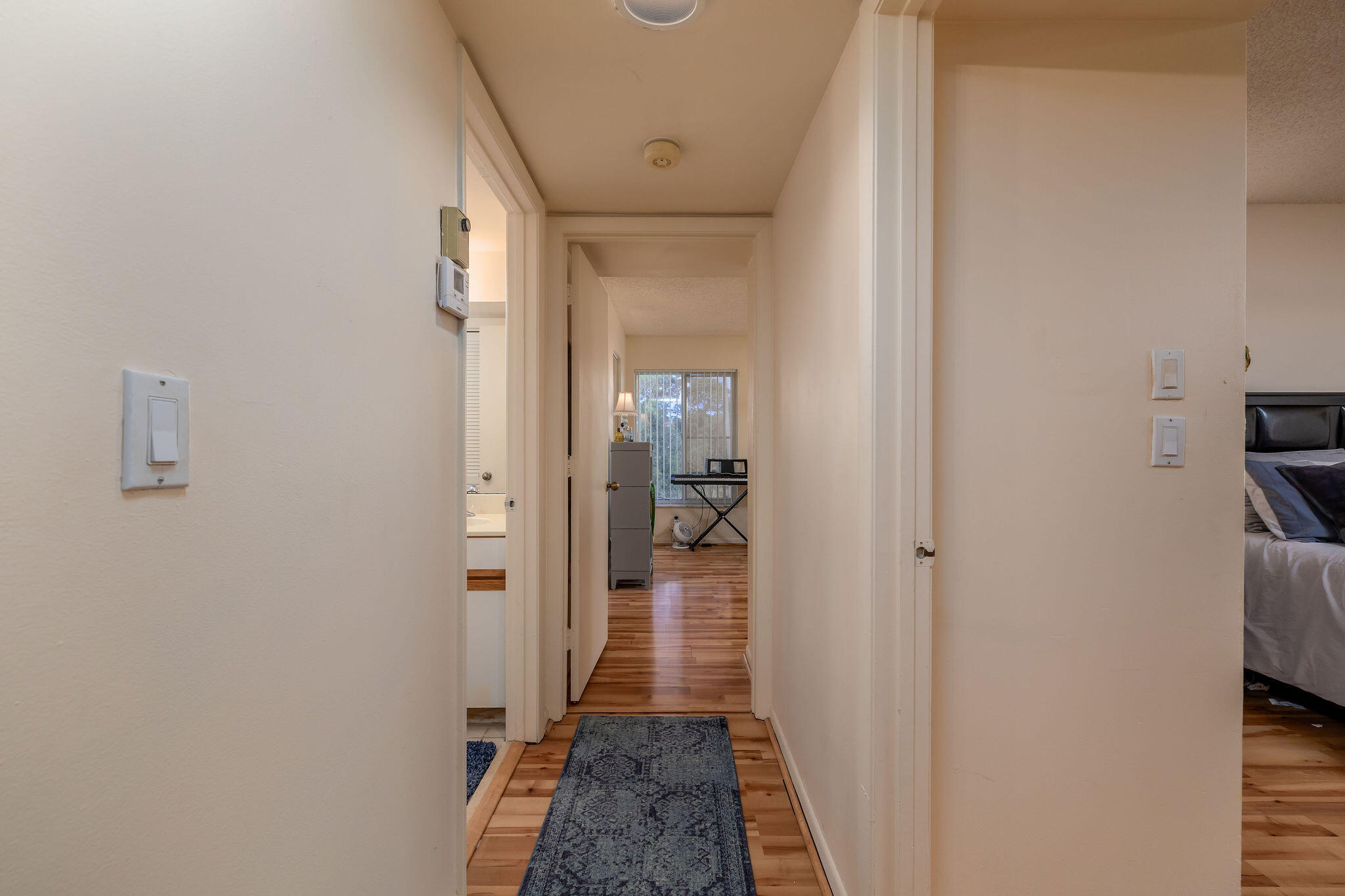 2500 Southeast Anchorage Cove, Unit D3 Port St. Lucie, FL 34952 - Photo 15 of 51 a view of a hallway with a livingroom and a bathroom with a sink