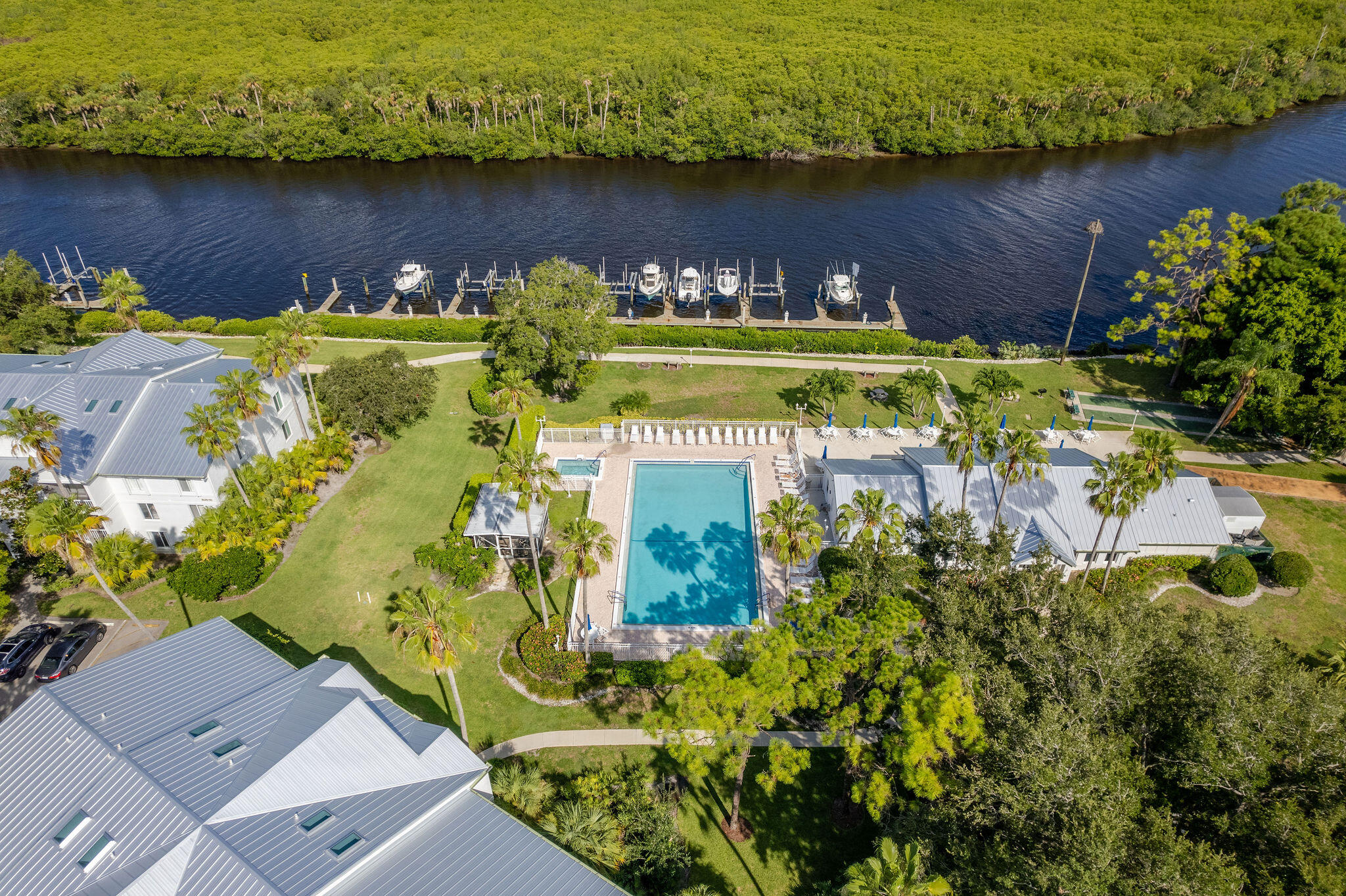 2500 Southeast Anchorage Cove, Unit D3 Port St. Lucie, FL 34952 - Photo 38 of 51 an aerial view of a house with a yard lake and trees all around