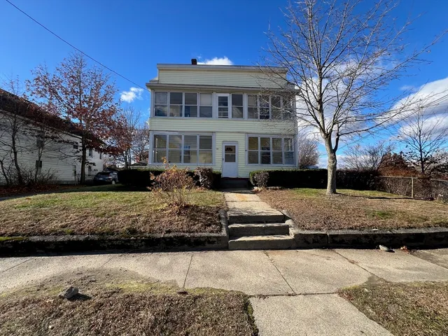 a front view of a house with a yard