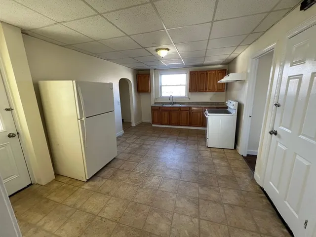 a view of a refrigerator in kitchen and livingroom