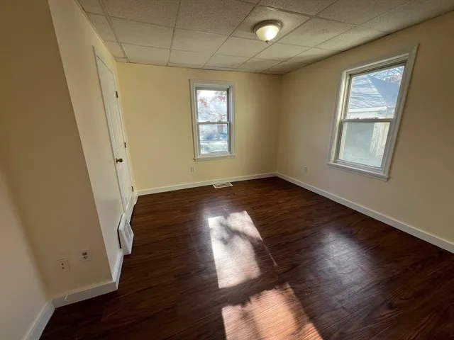 a view of room with window and wooden floor