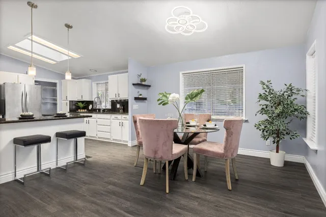 a view of a dining room with furniture window and wooden floor