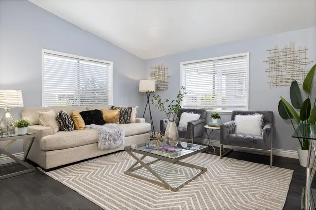 a living room with furniture and a potted plant