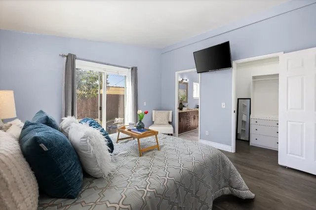 a bedroom with a bed and a flat screen tv