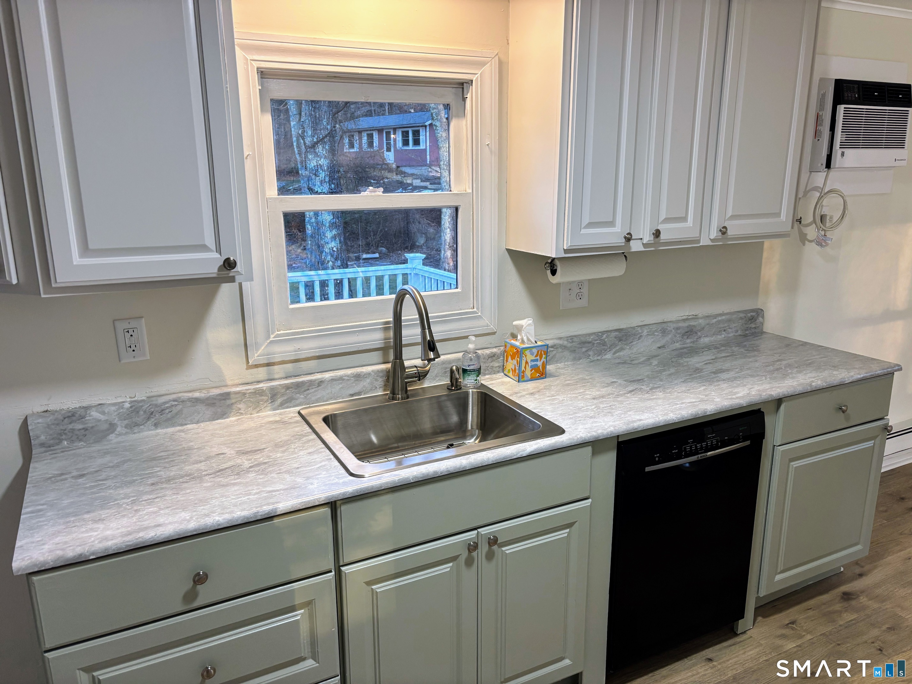 a kitchen with granite countertop a sink and cabinets