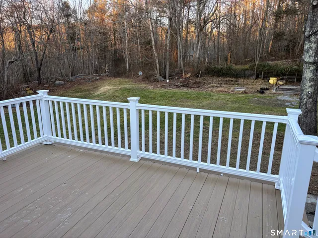 a view of deck and trees with wooden fence