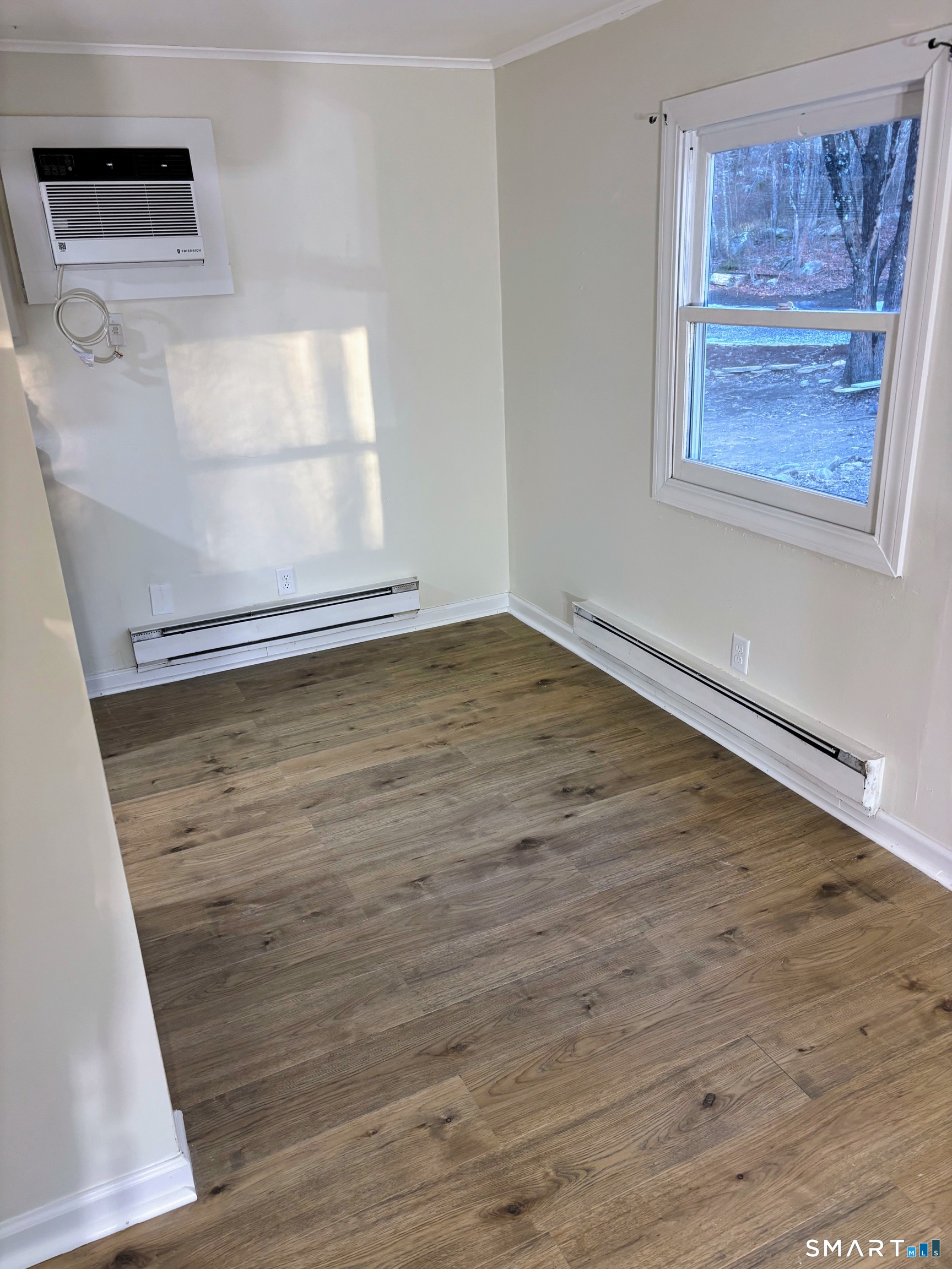62 Rattling Valley Road Deep River, CT 06417 - Photo 10 of 19 a view of an empty room with wooden floor and a window