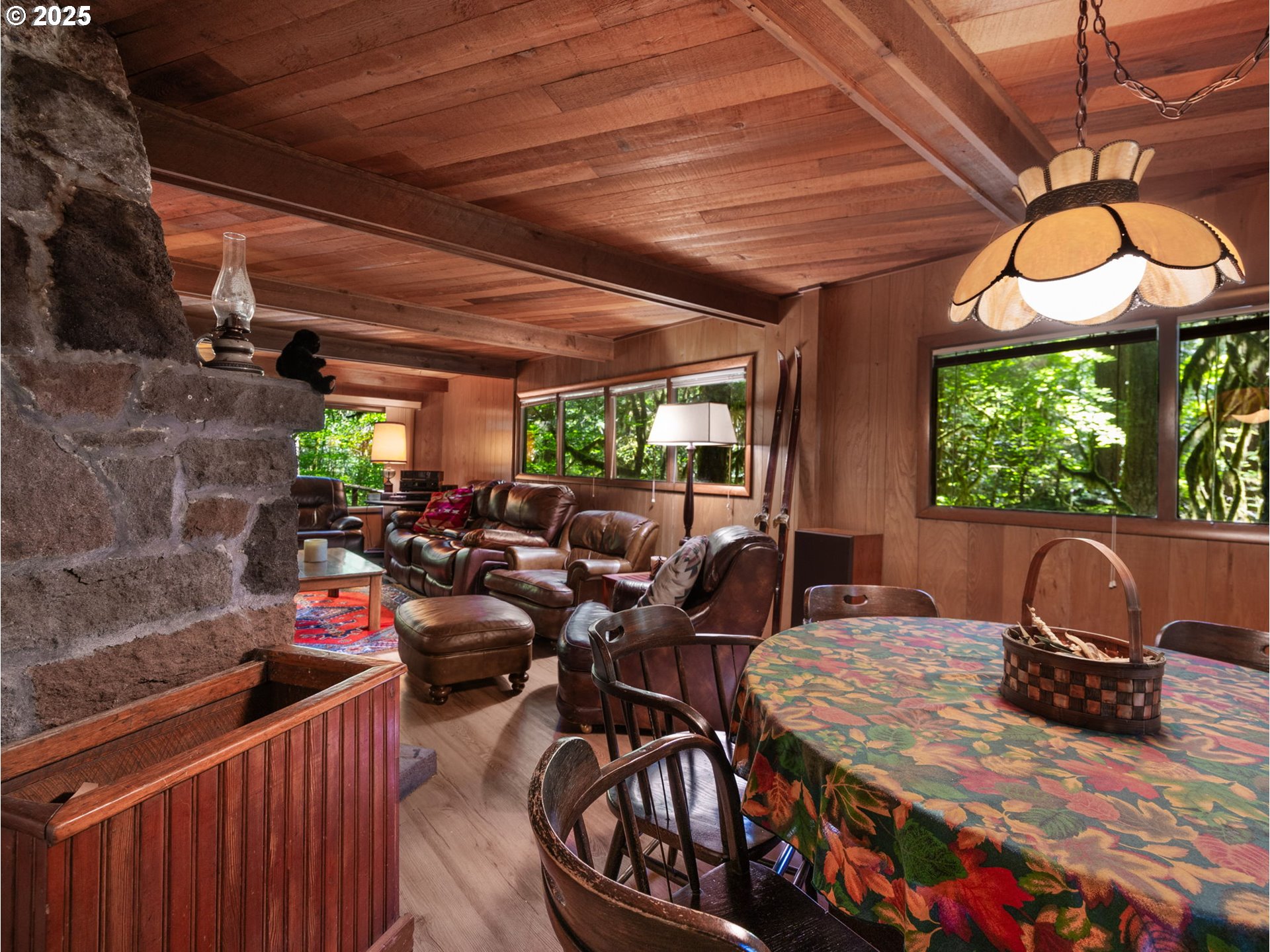 26811 East Road 15 Rhododendron, OR 97049 - Photo 12 of 47 a view of a patio with table and chairs potted plants with wooden floor