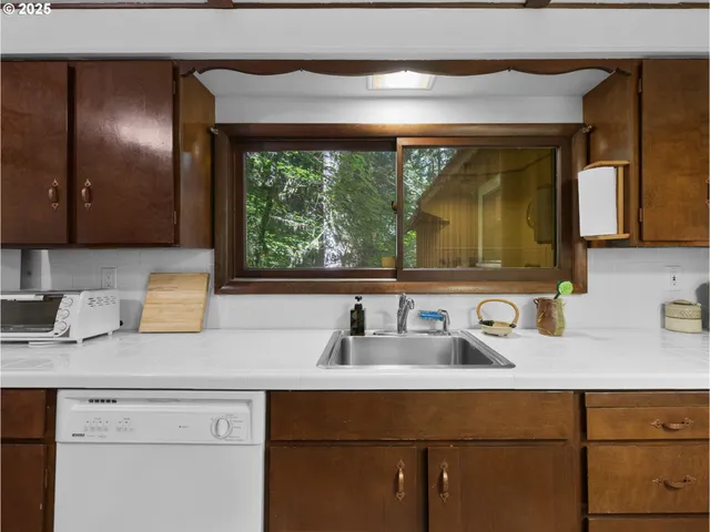 a kitchen with a sink and a mirror