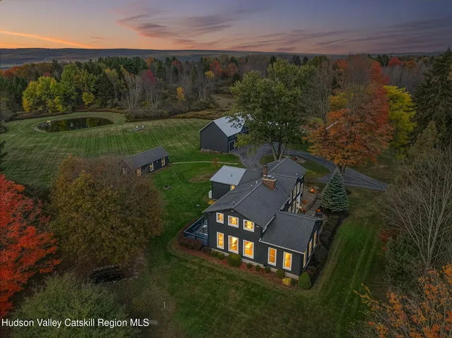 an aerial view of a house with garden space and outdoor seating
