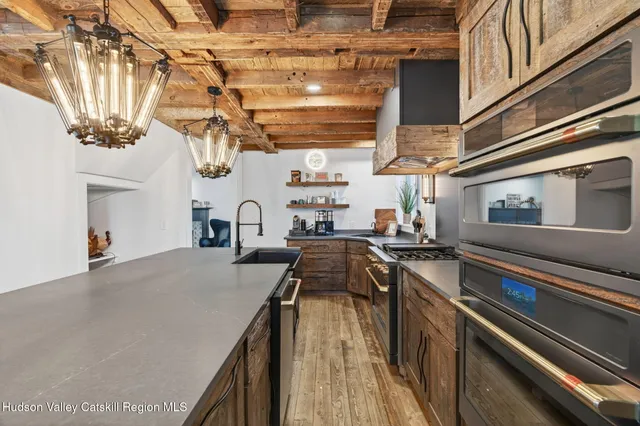 a kitchen with stainless steel appliances granite countertop a stove and a sink