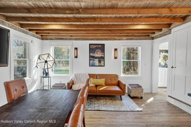 a living room with furniture a fireplace and a table