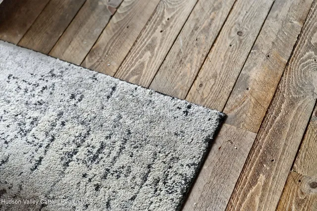 a living room with furniture flat screen tv and a large window