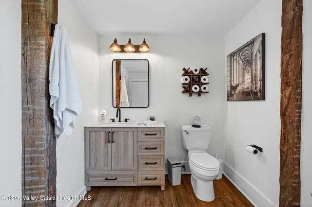 a kitchen with granite countertop wooden floors and stainless steel appliances