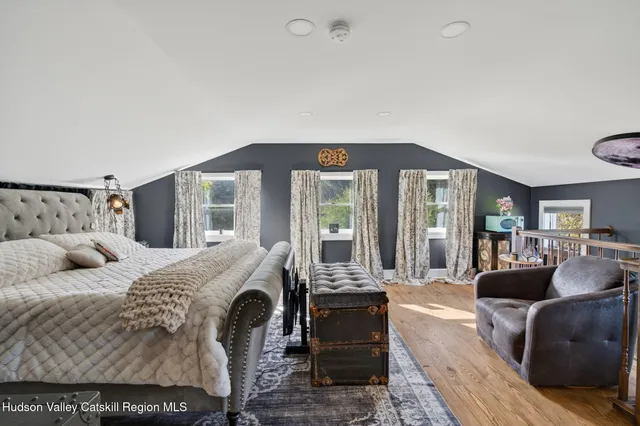 a aerial view of a house with a yard and large tree