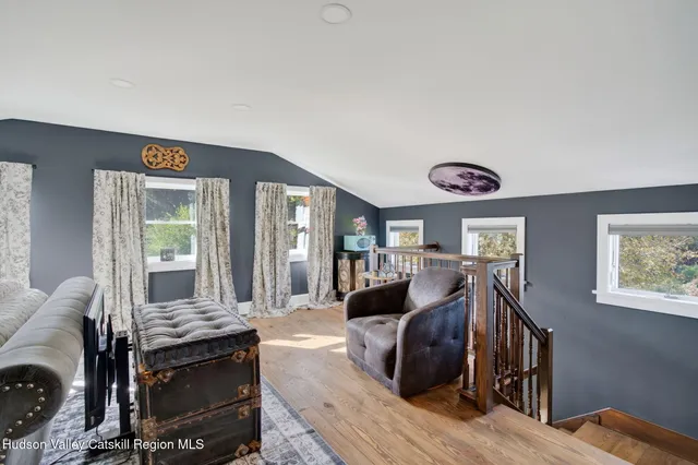 a bedroom with furniture and a large window