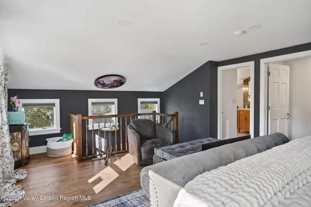 a living room with furniture a rug and a large window