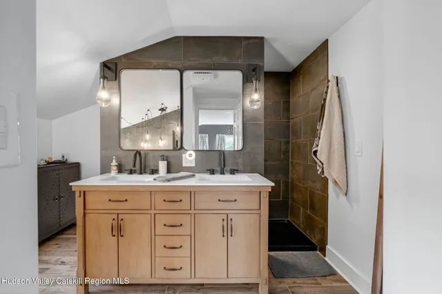 a bathroom with a granite countertop sink toilet and shower