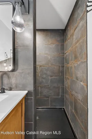 a living room with furniture a flat screen tv and a large window