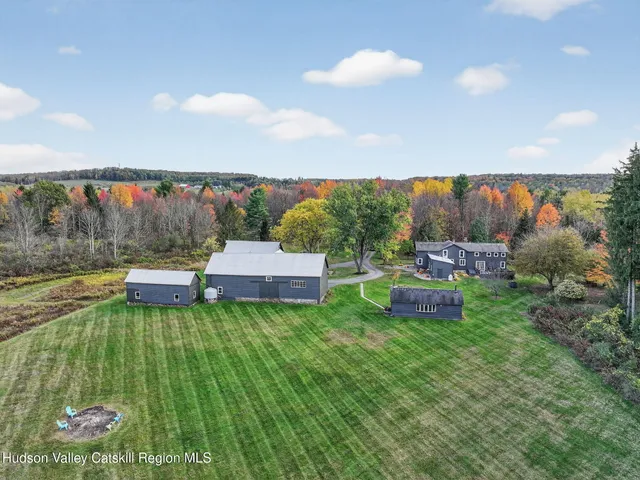 a view of a patio with a dining table and chairs with wooden floor and fence