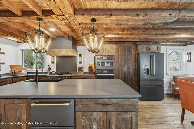 a kitchen with a sink and a stove next to a window