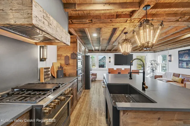 a kitchen with stainless steel appliances granite countertop a stove and a microwave