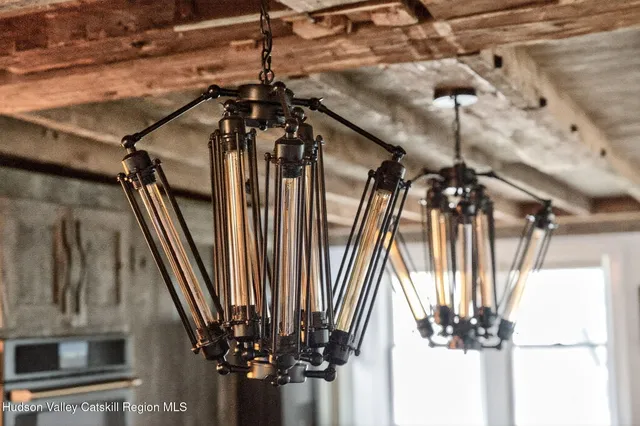 a view of a hallway with a dining table and chairs