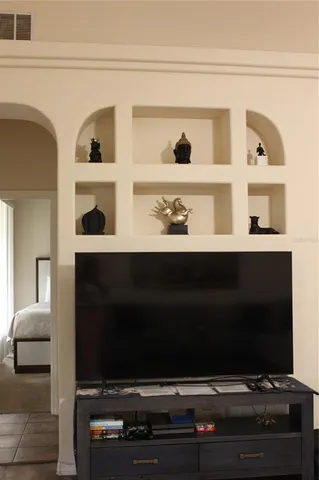 a bedroom with a large bed and a couch