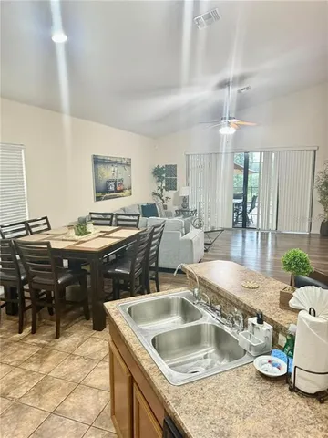a kitchen with a stove a sink a dining table and chairs