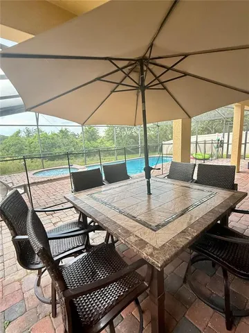 a living room with furniture a couch and paintings on the wall