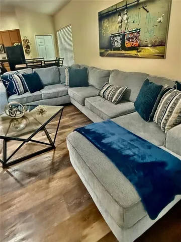 a dining room with furniture and wooden floor