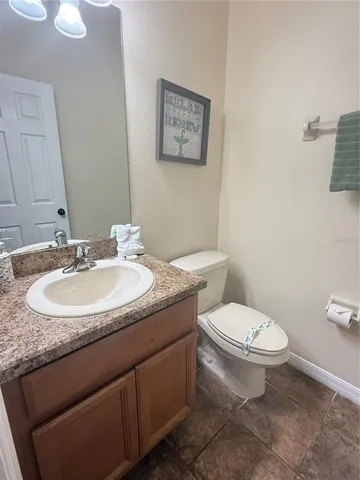 a living room with furniture and a painting on the wall