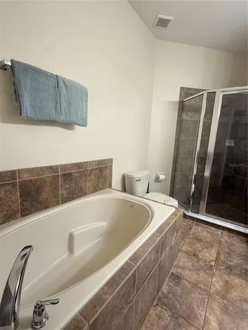 a bedroom with a bed and a night stand