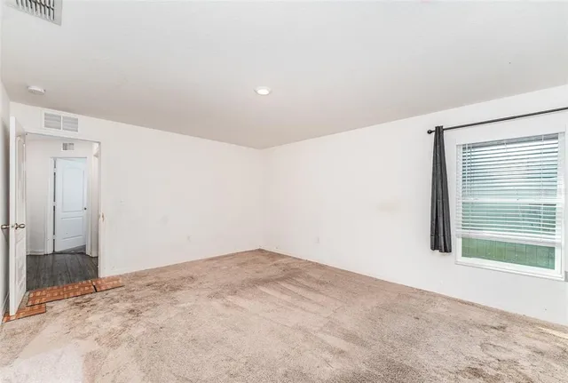 a bedroom with a bed and a potted plant