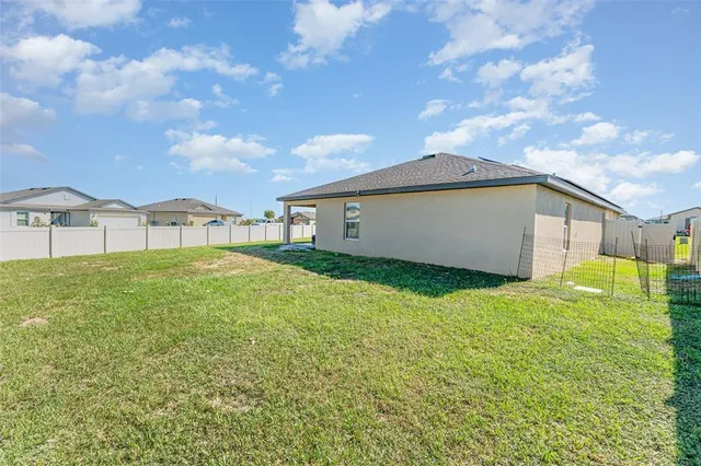 a view of an house with backyard space and balcony