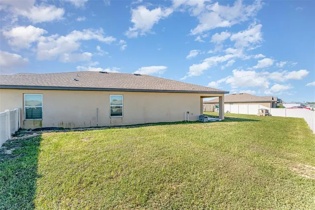 a backyard of a house with lots of green space and garden