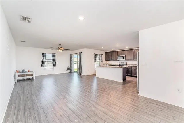 a view of kitchen with furniture and wooden floor